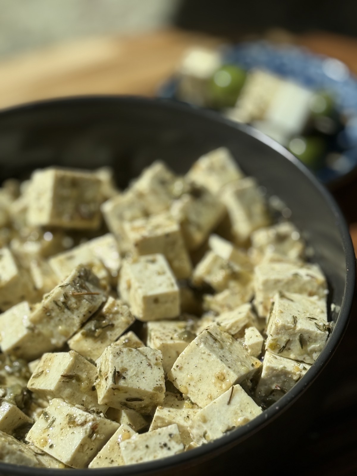 a bowl of marinated tofu cubes.