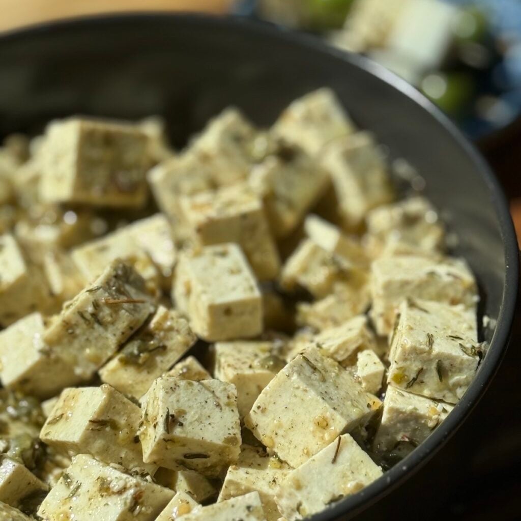 a bowl of marinated tofu cubes.