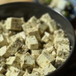 a bowl of marinated tofu cubes.