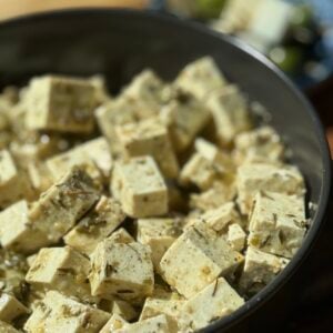 a bowl of marinated tofu cubes.