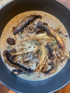 overhead view of the finished vegan mushroom soup with all the toppings
