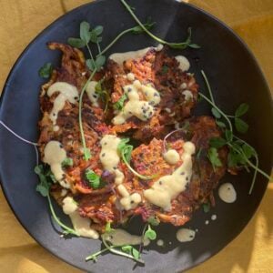 overhead view of a plate of vegetable bhajis (vegan fritters).