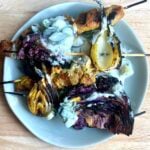 pork and veggie satay on skewers with coconut cucumber dressing.