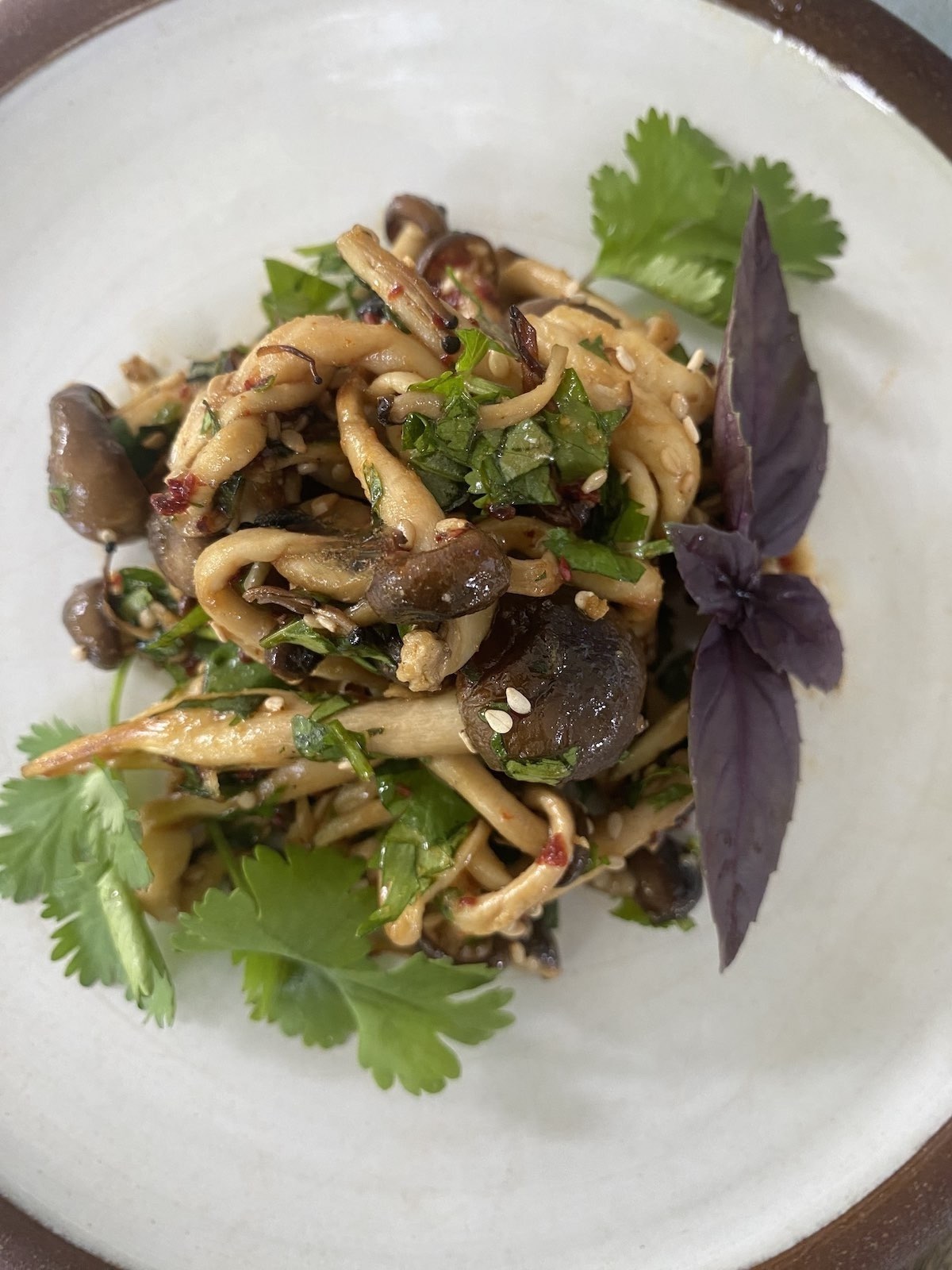 plate of spice marinated mushrooms with cilantro garnish.