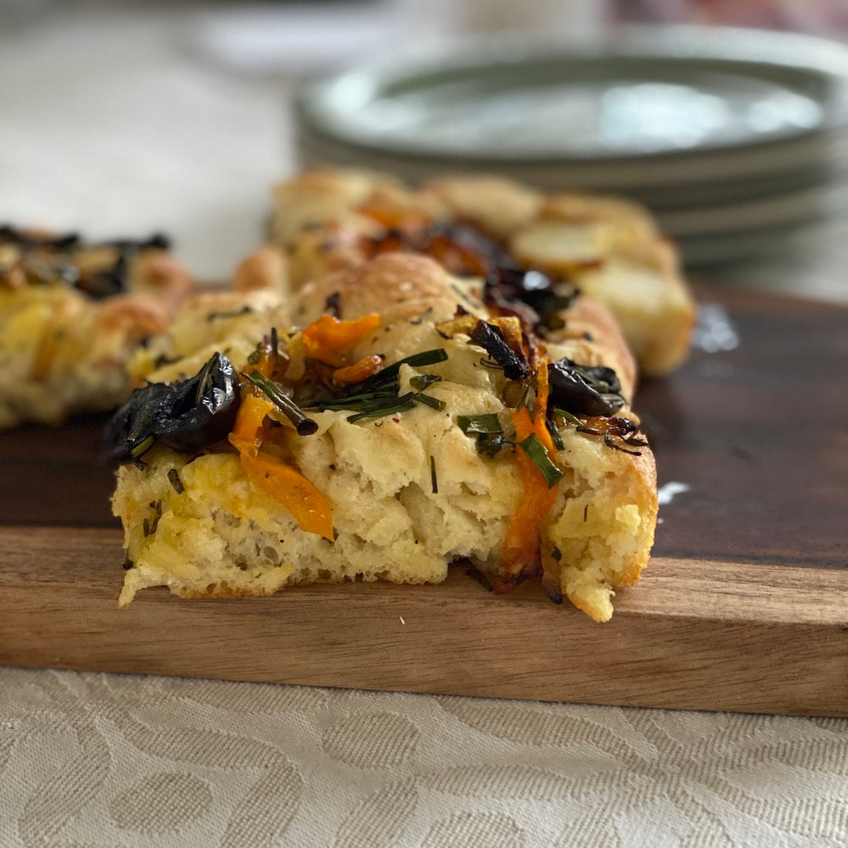 side view of a slice of decorated focaccia.