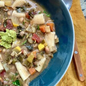 close up of bowl of miso herb minestrone, a vegan version of "soupe au pistou".