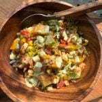 single serving of smoky rice salad with cilantro lime crema drizzled over top.