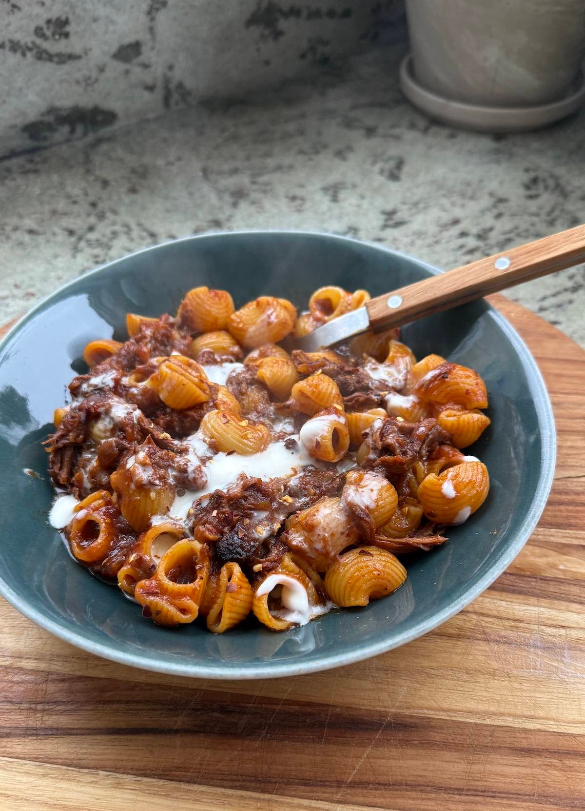 serving of beef ragu served with pasta.