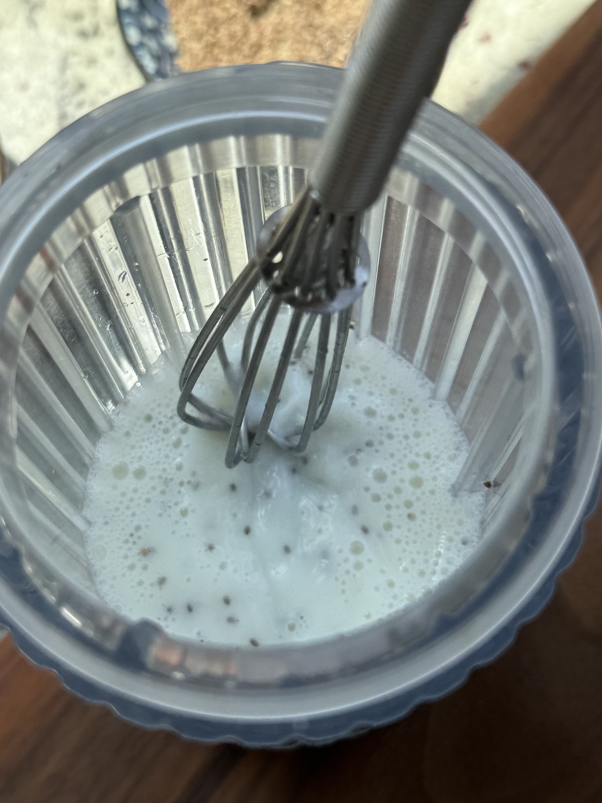 whisking chia seeds into skim milk in blender carafe.