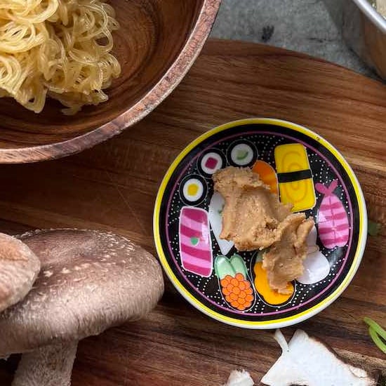 close up of white miso paste in dish ready to be added to recipe.